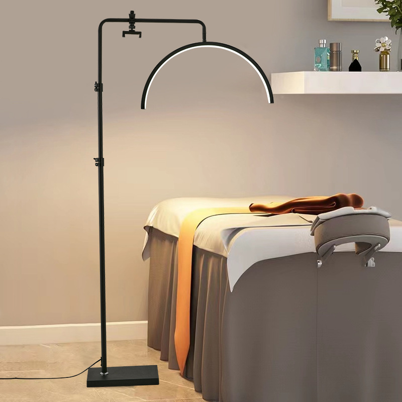 Demonstrating professional half moon lash lamp to provide lighting beside the beauty bed